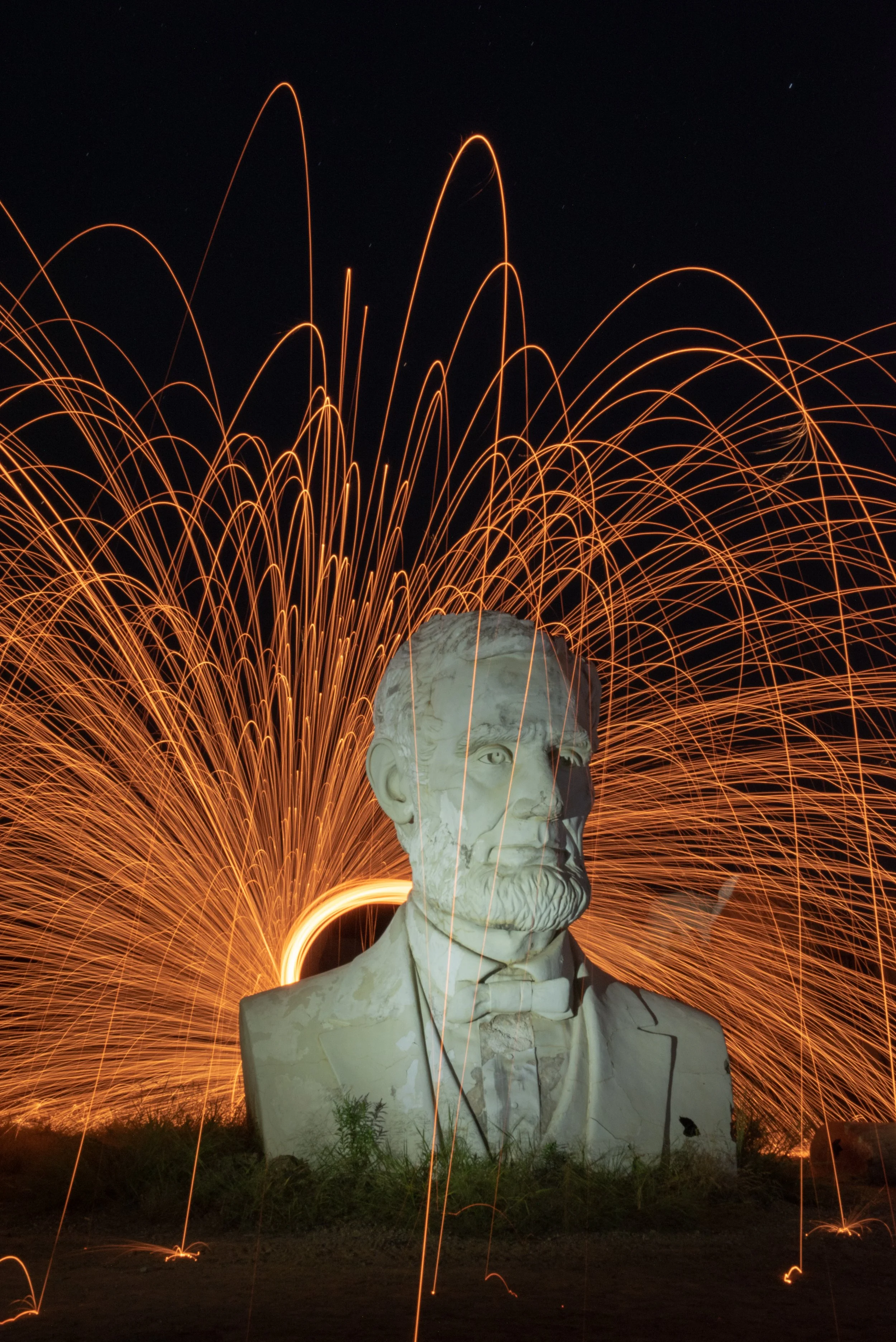 Abe - Abandoned President Park with the heads of past presidents still survives just like our Country even in the darkest days we find a way to survive. Using homemade fireworks I created the flames behind Abe's Head