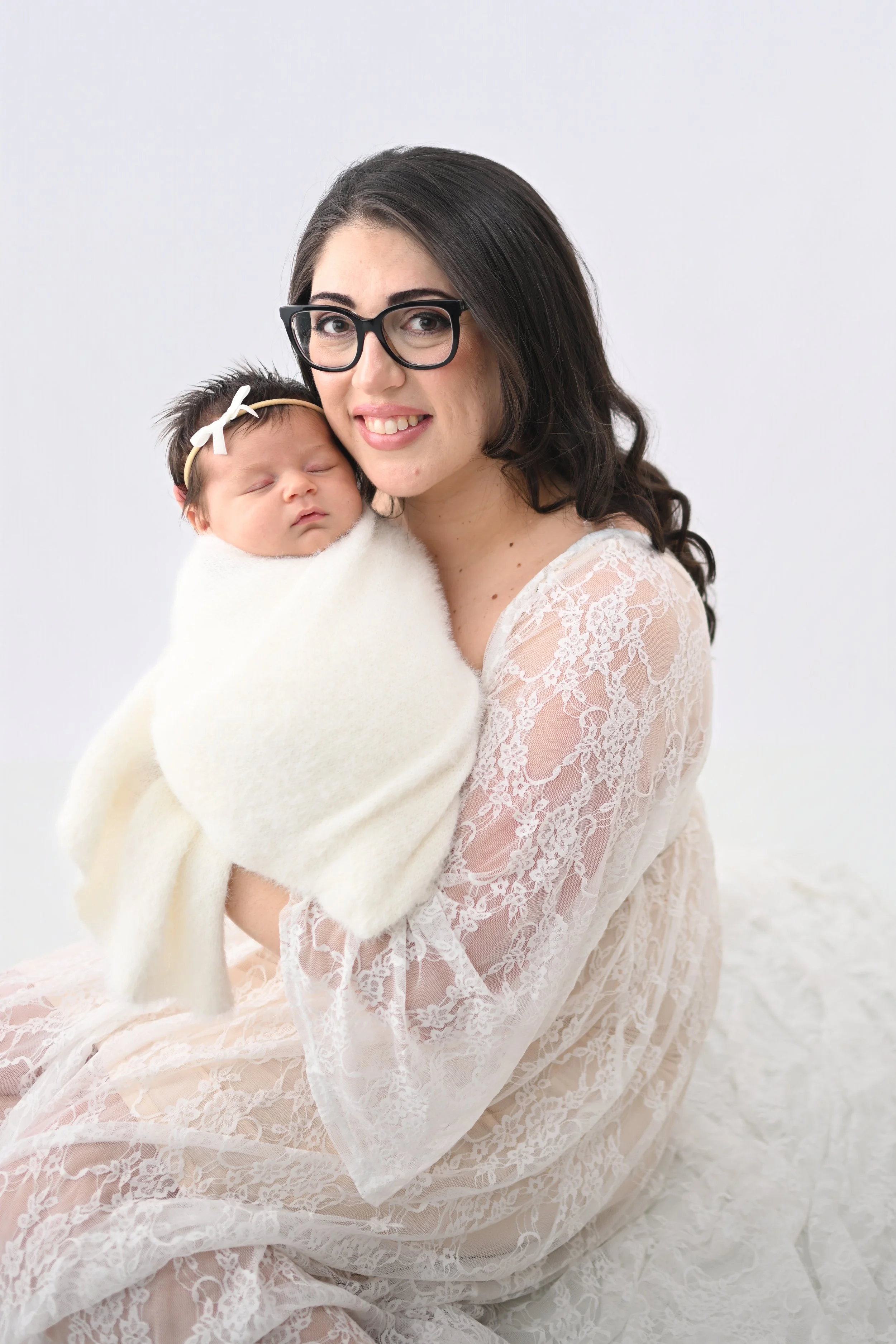 Mother holding newborn baby during Satellite Beach portrait session