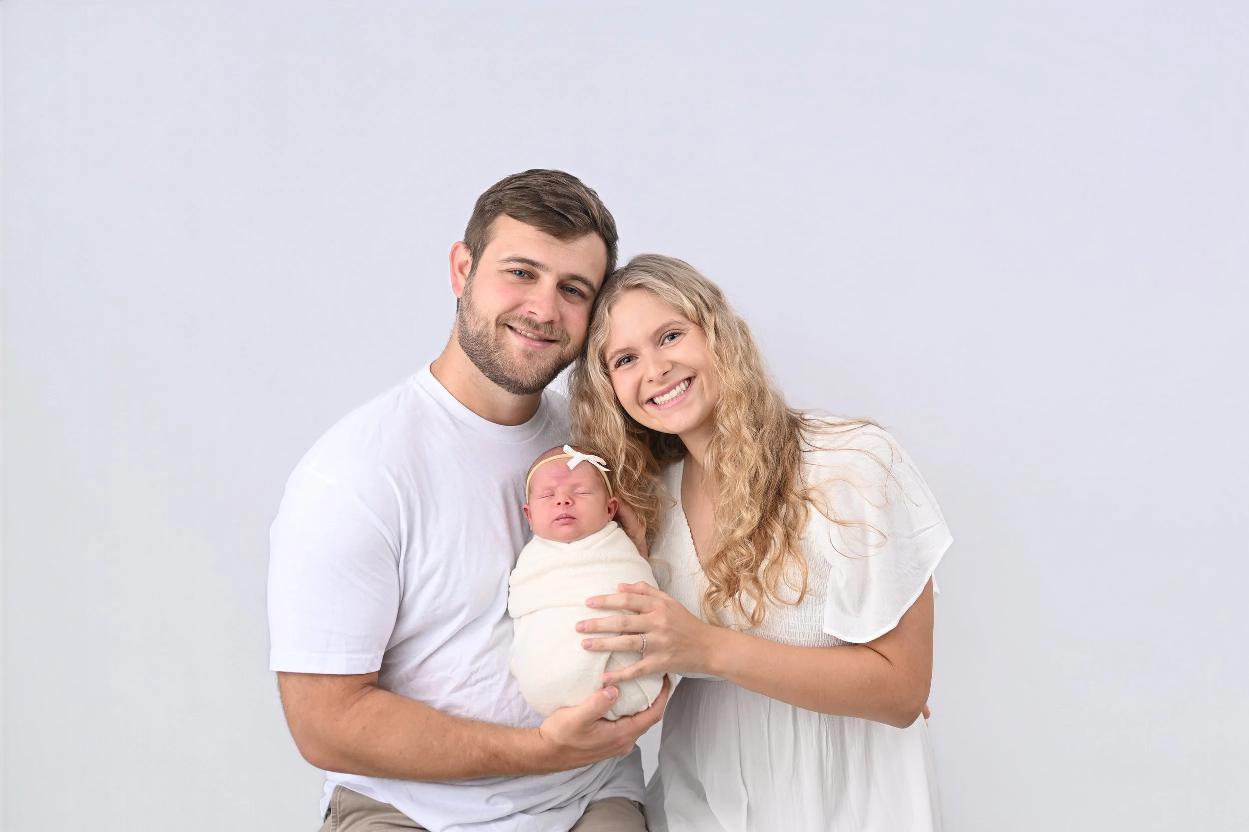 Parents with newborn baby at Beachside Portraits photography studio