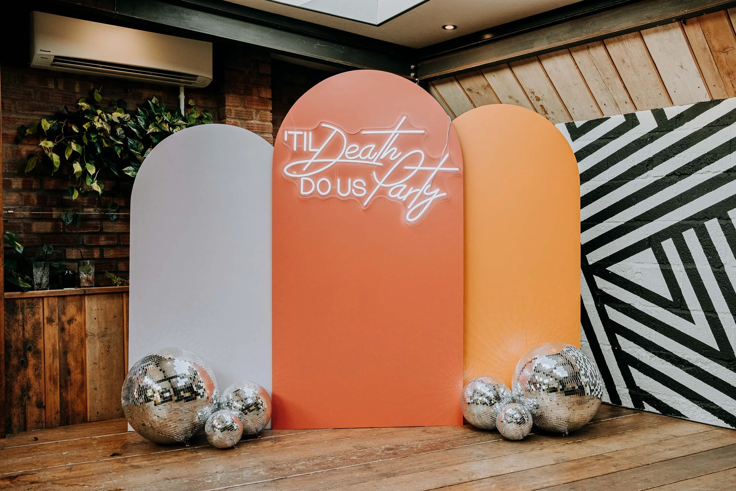 peach coloured arch backdrop and disco balls