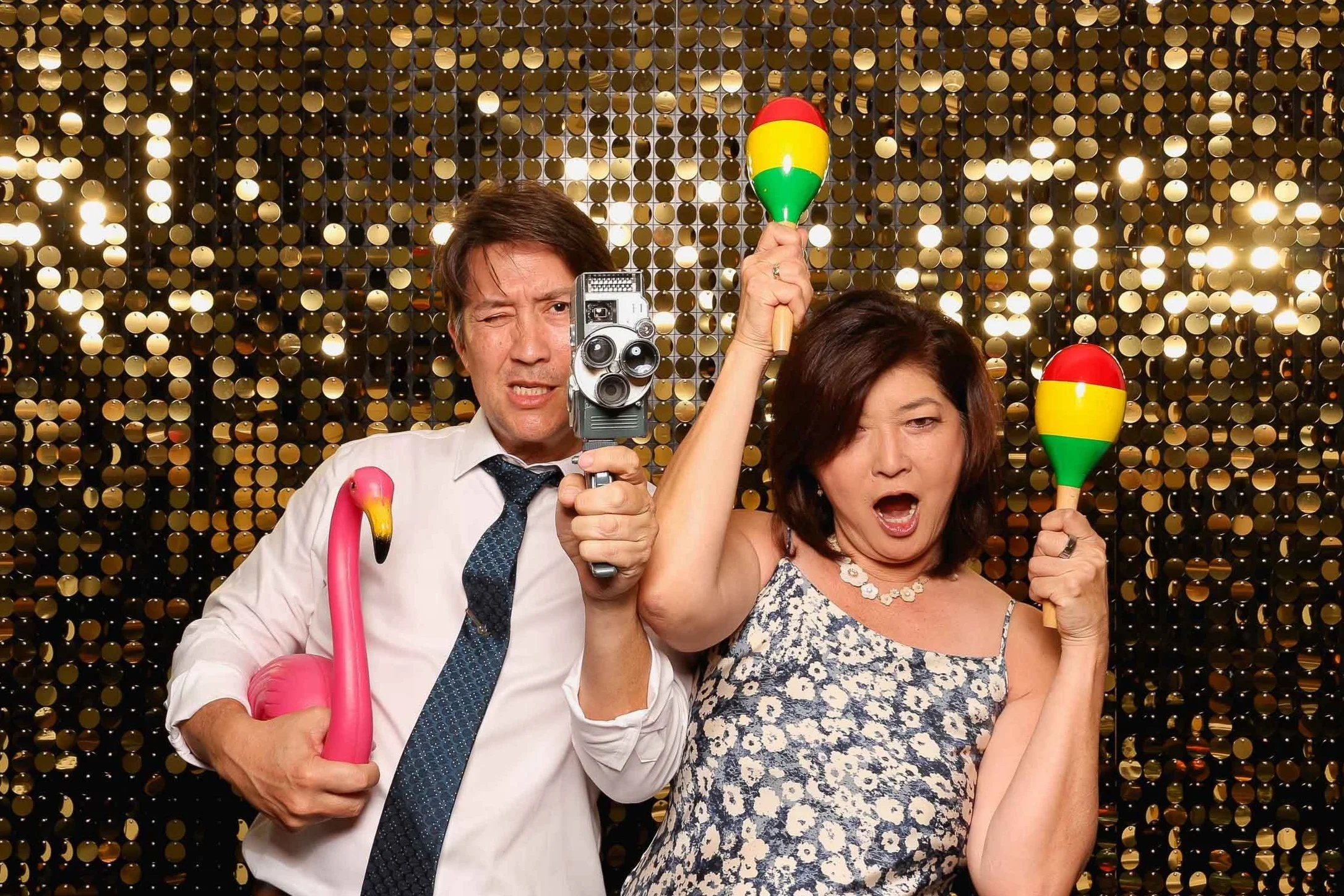 couple using Photo Booth with props