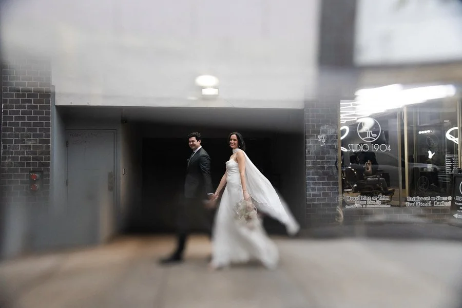 Candid artistic photo of a couple walking to Flora the Venue in San Diego Gaslamp Quarters. San Diego wedding.