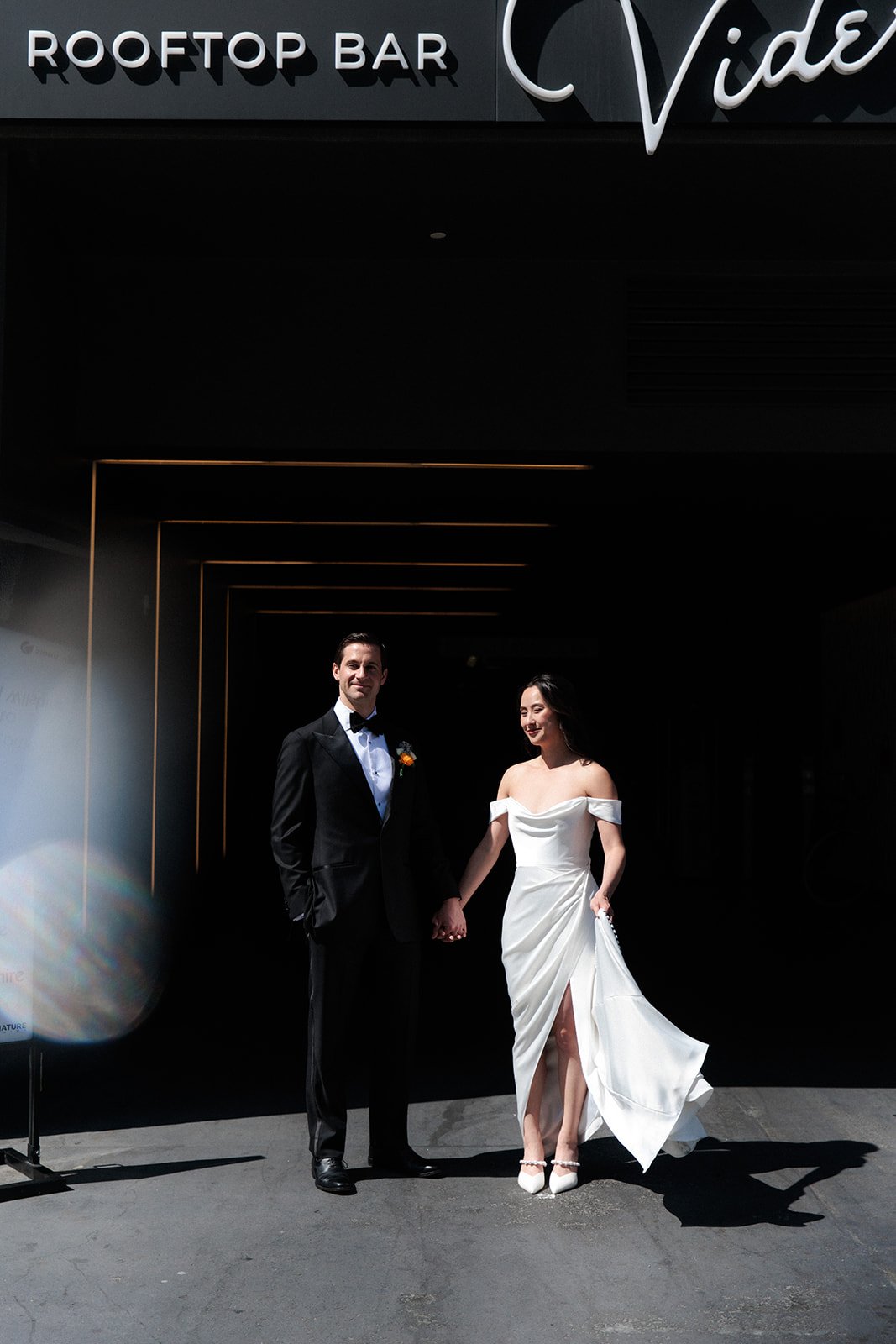 San Diego courthouse elopement photos of a bride and groom standing holding hands 