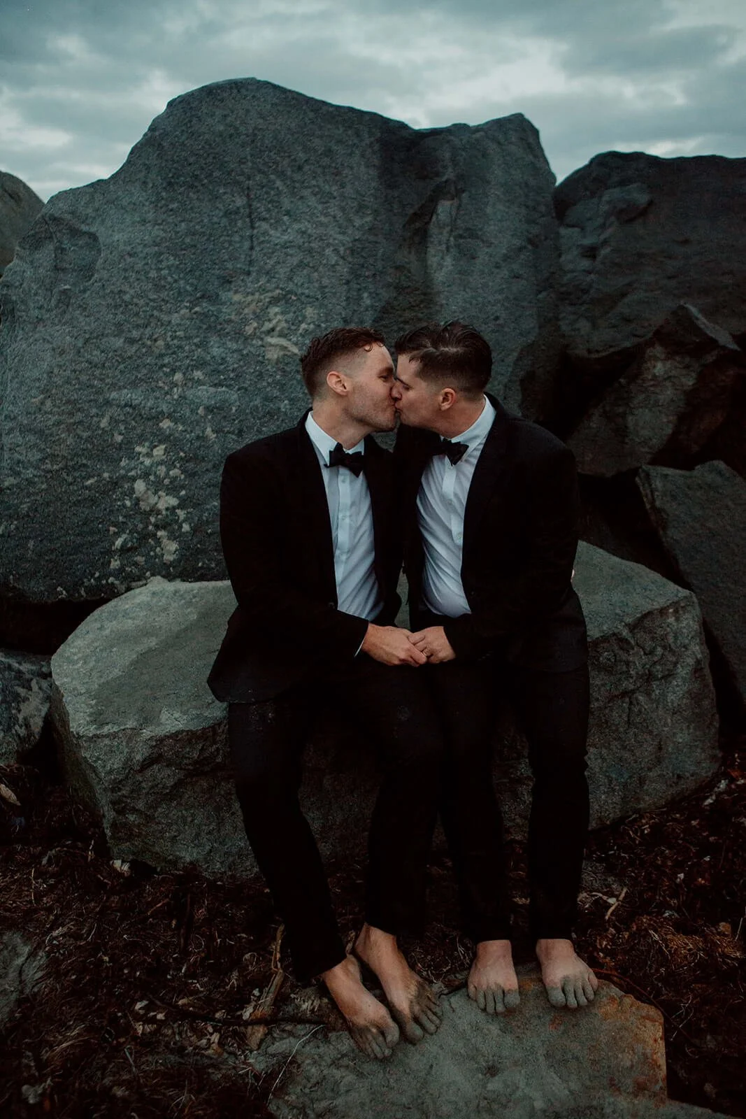 Two grooms kiss on Coronado beach for their San Diego Courthouse wedding sunset photos.
