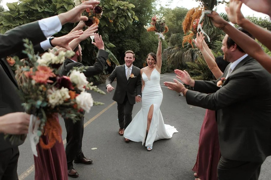 Bride and groom laugh and celebrate at their San Diego Botanical Gardens Wedding