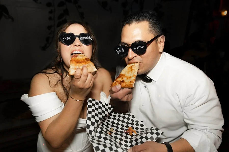 Couple eats pizza at their San Diego wedding held at Flora the Venue.