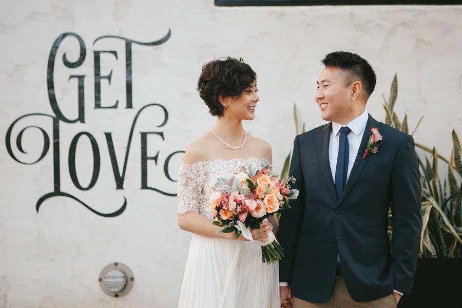 Bride and groom smile at their downtown San Diego wedding.