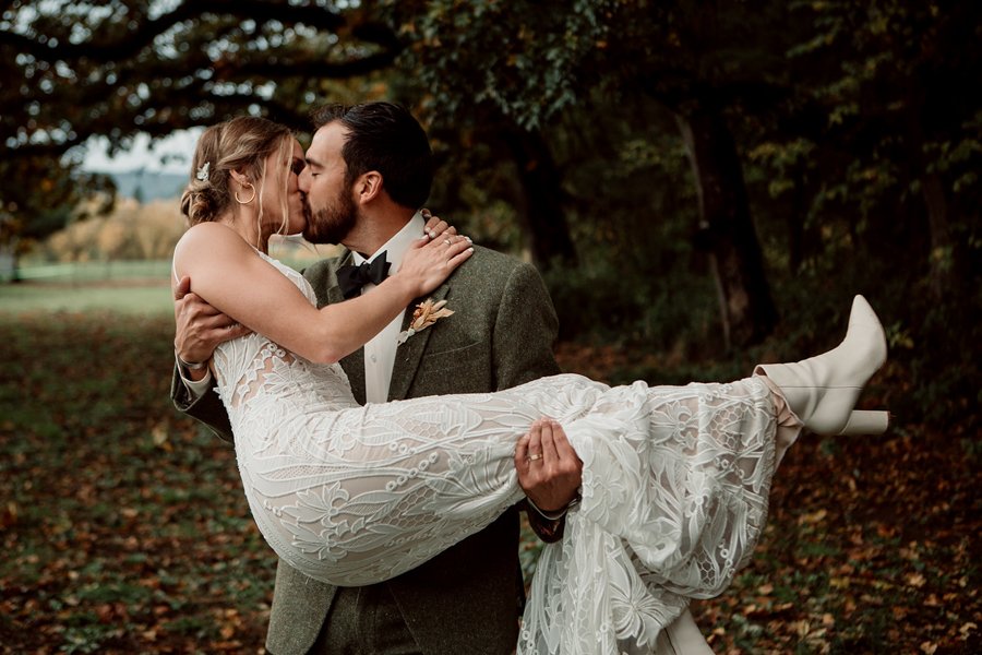 Groom picks up his bride at their San Diego wedding.