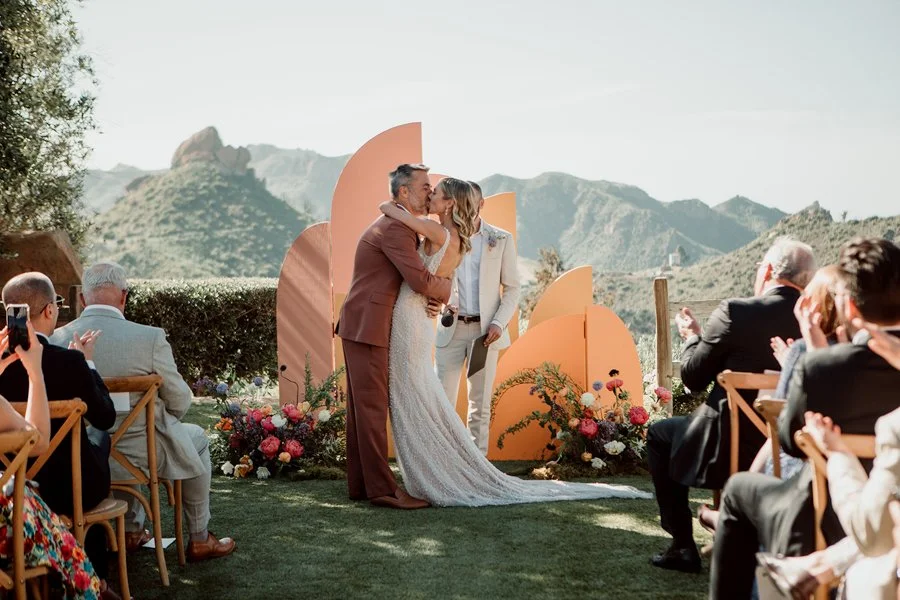 First kiss at a Los Angeles wedding ceremony held at Cielo Farms.