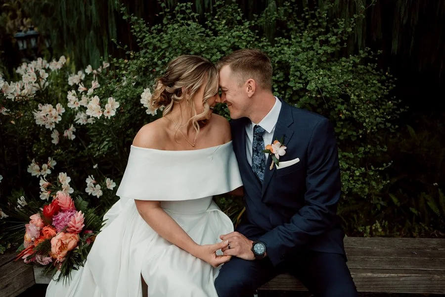 Couple smiles at their San Diego Botanical Gardens wedding.