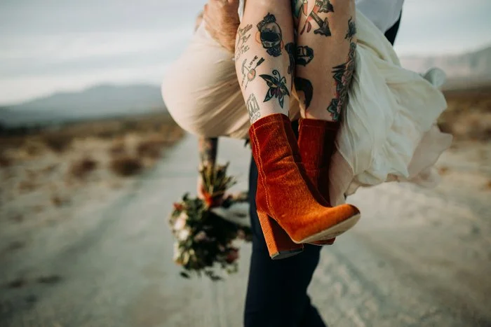 Groom picks up bride with red boots in San Diego.
