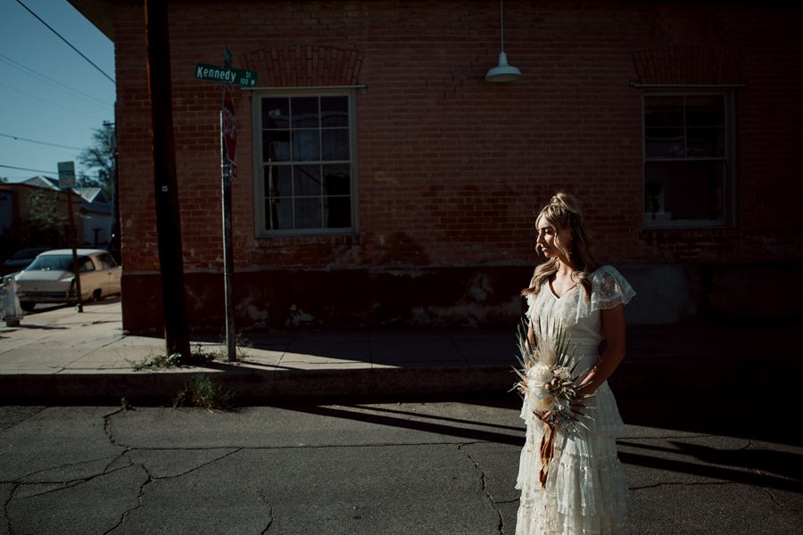 Bride stands on street for her Tucson, Arizona wedding. 
