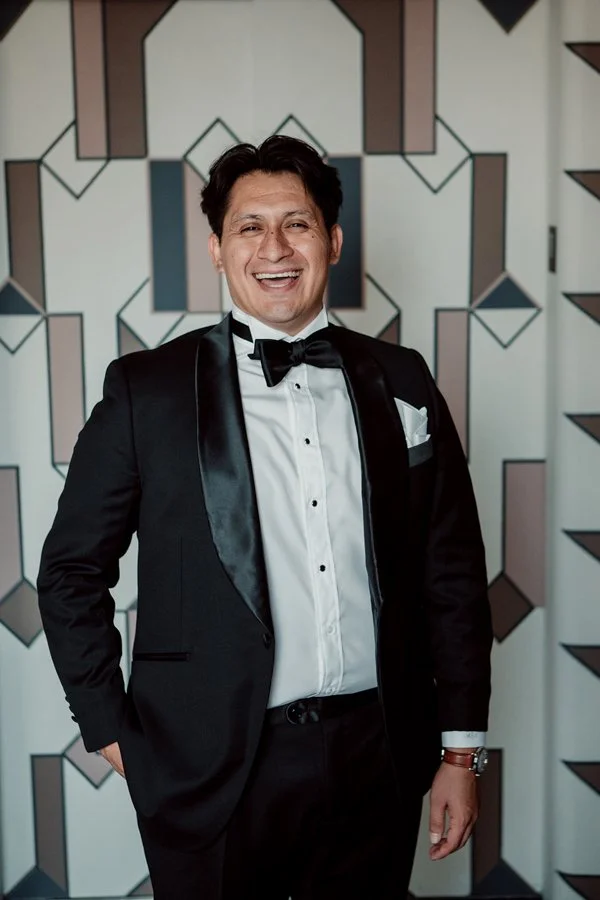 Groom laughs during a candid photograph.