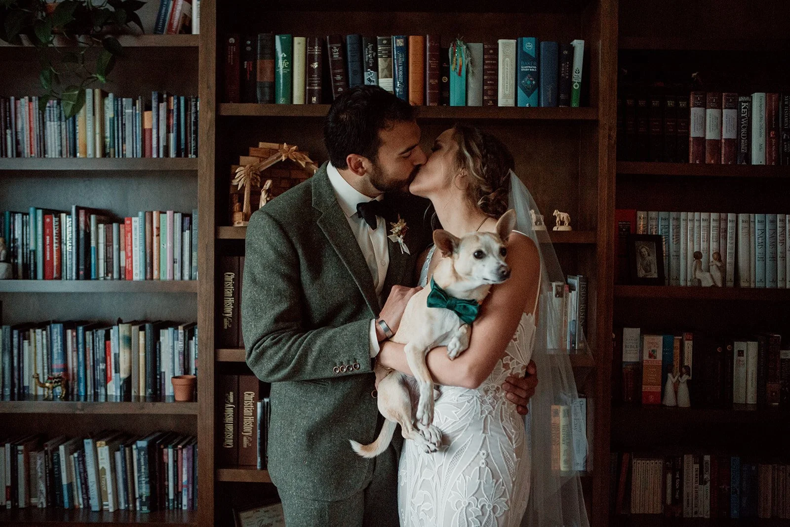 San Diego courthouse wedding couple kisses in front of books.