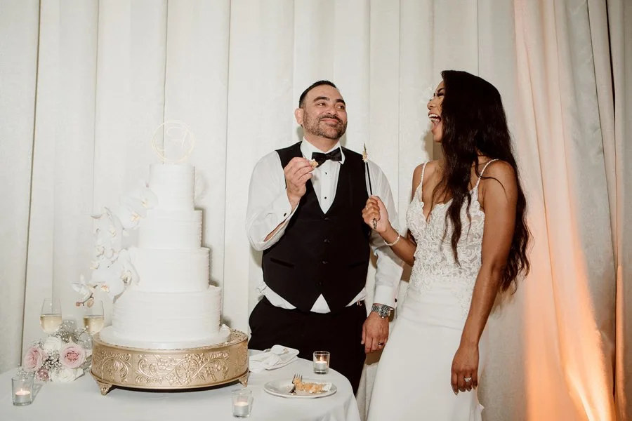 Bride and groom cut their wedding cake in San Diego