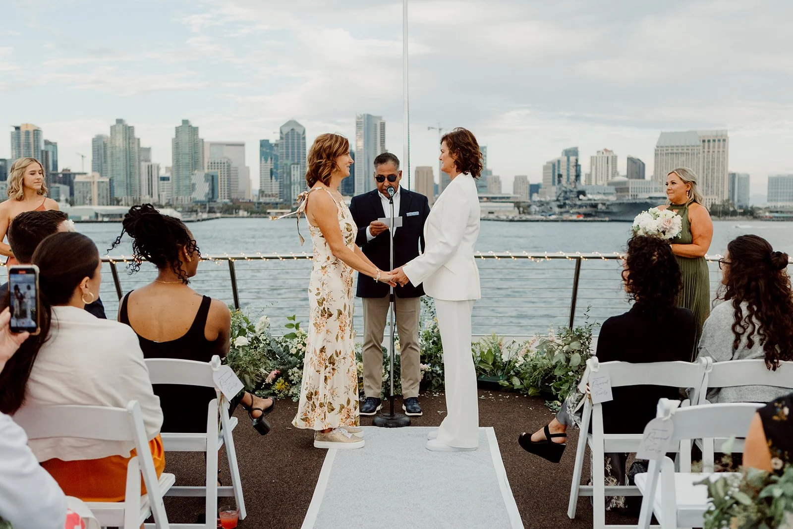 Brides exchange vows on a boat for their San Diego Bay wedding.