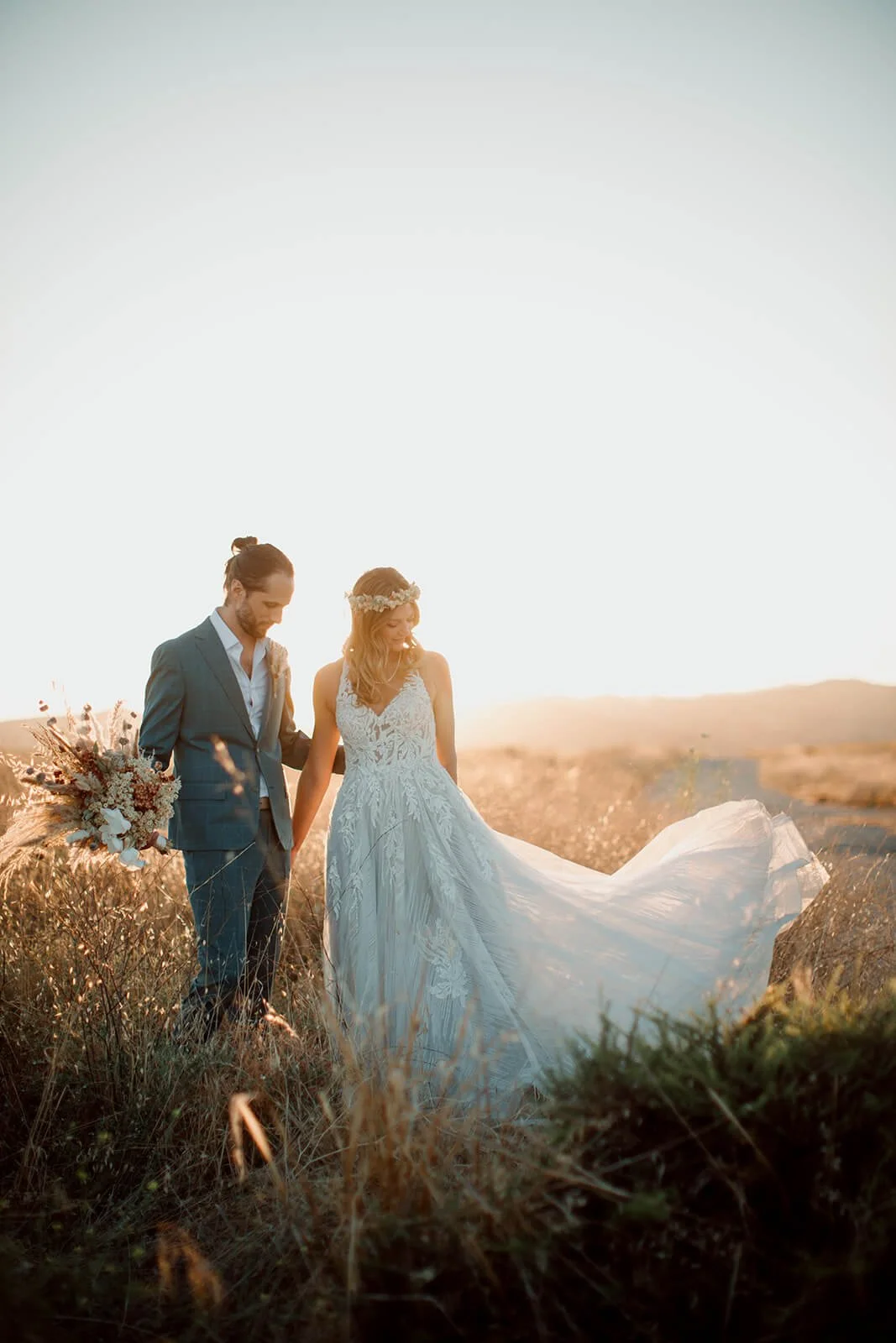San Diego wedding photo of a couple in a field at sunset.