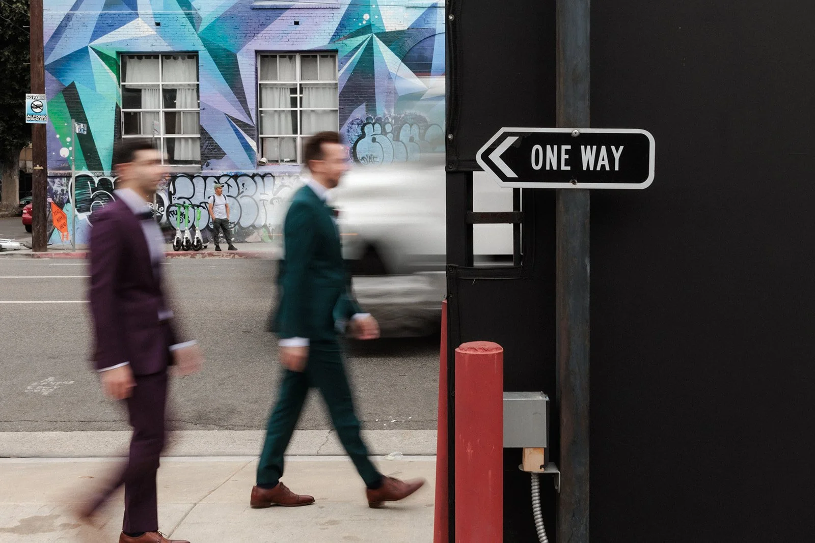 Two grooms walking in downtown Los Angeles streets.