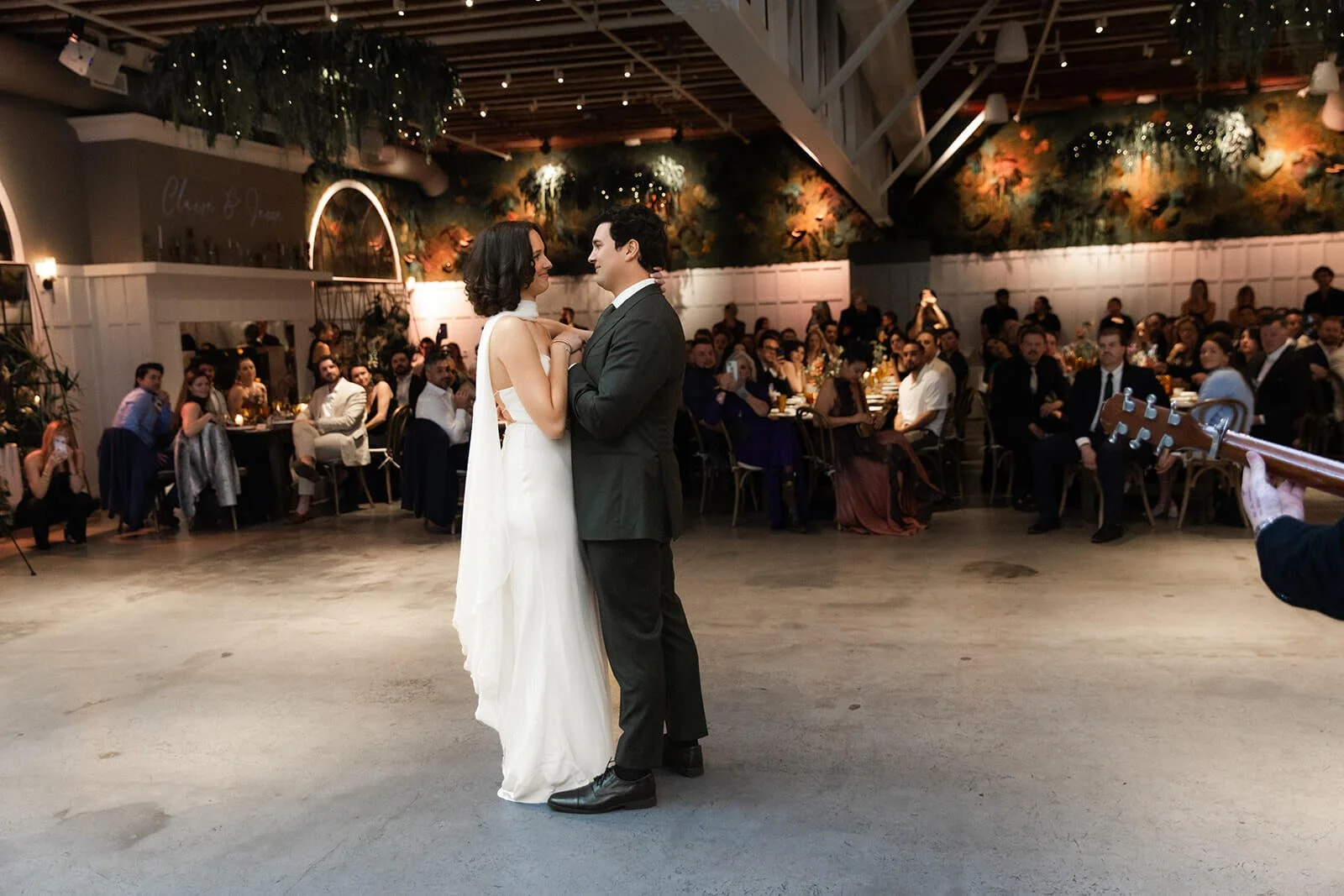 Wedding first dance at Flora the venue in downtown San Diego. Bride and groom dance together in front of their wedding guests.