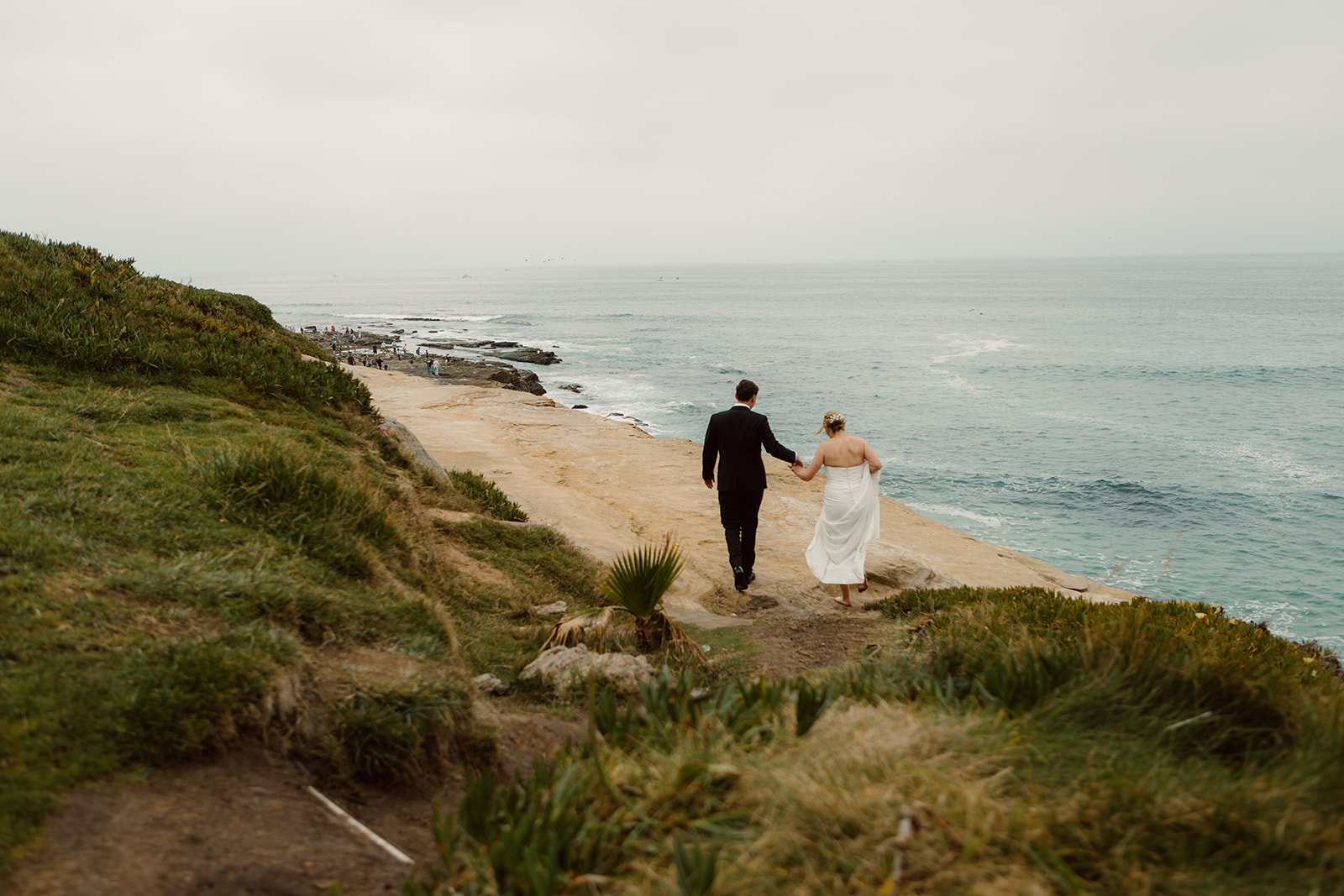 Bride an groom at La Jolla Cove for their elopement held at the Wedding Bowl.