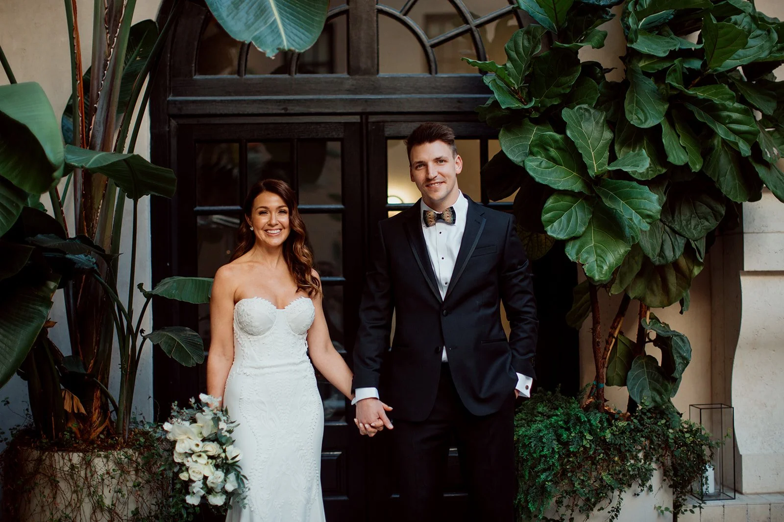 San Diego Gaslamp Quarters wedding. Couple stands holding hands and smiling.
