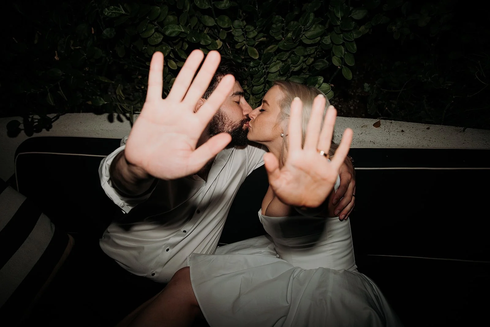 San Diego wedding photographer shoots couple kissing plaufully.