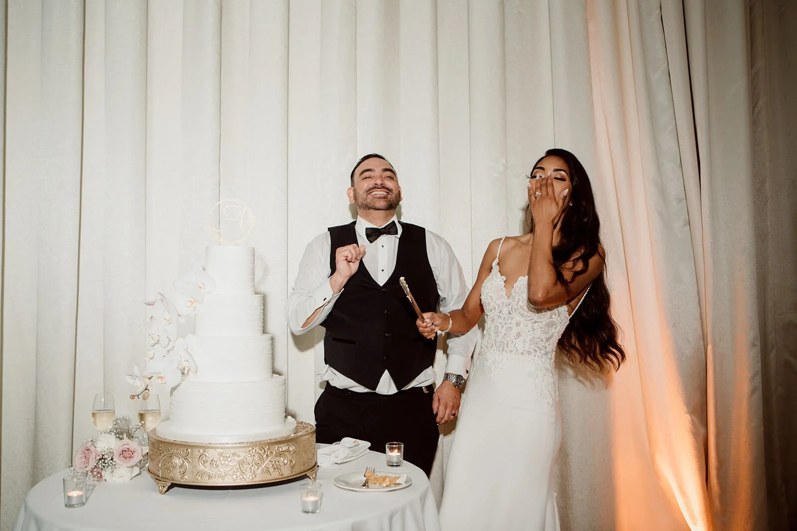 Bride and groom cut their wedding cake in San Diego