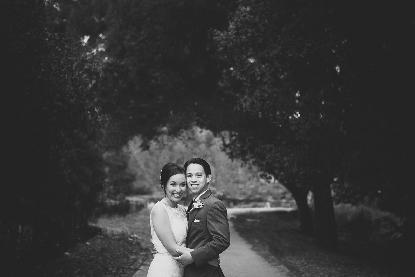 Balboa Park wedding photography, couple embraces under a tree.