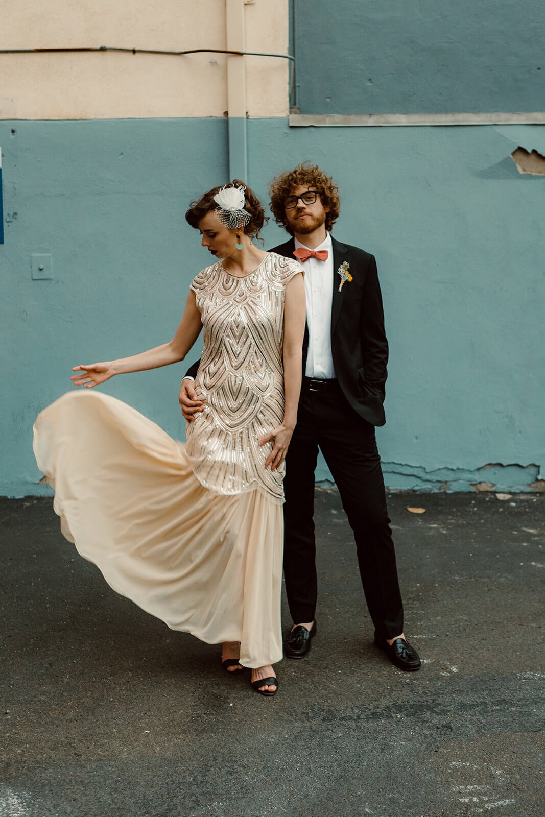 San Diego Courthouse wedding couple for their portraits in front of a downtown wall.