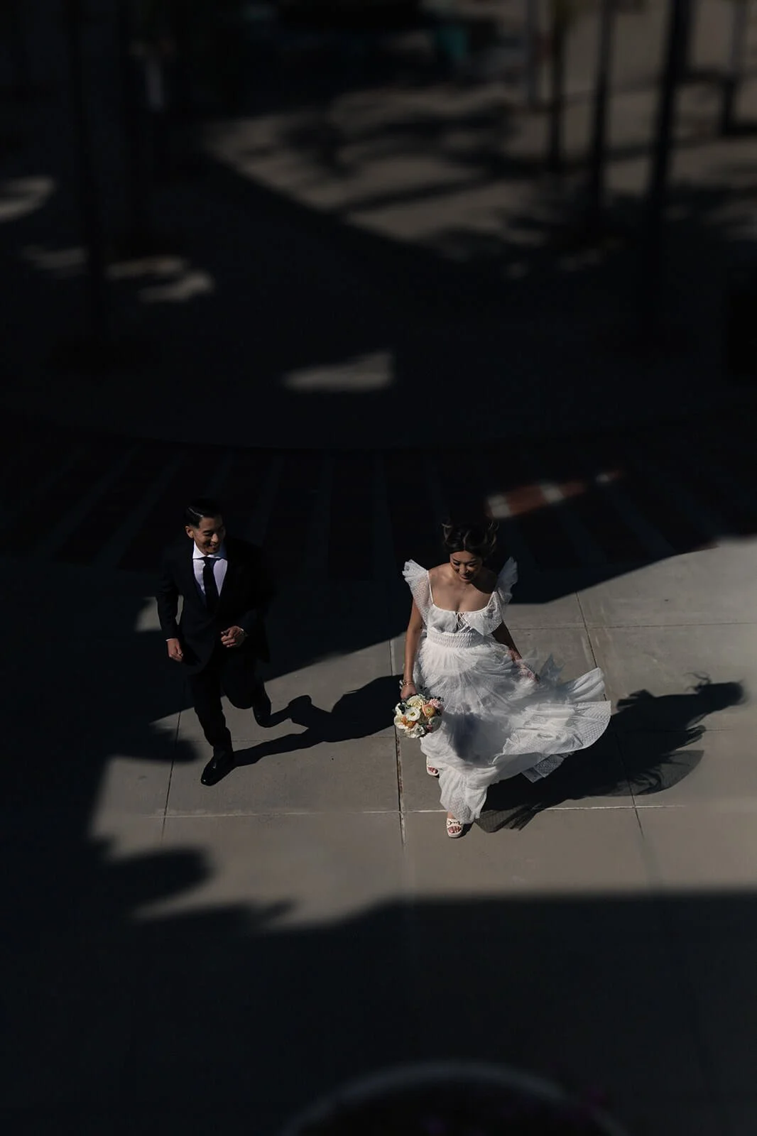 Bride and groom walk in downtown San Diego for their wedding ceremony.