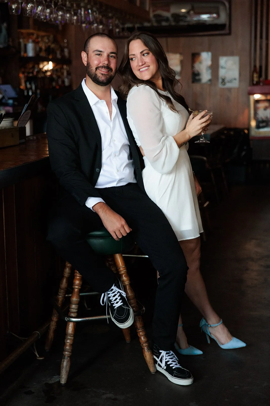 Fianceé smiles and leans against her groom to be for their San Diego engagement photo shoot.