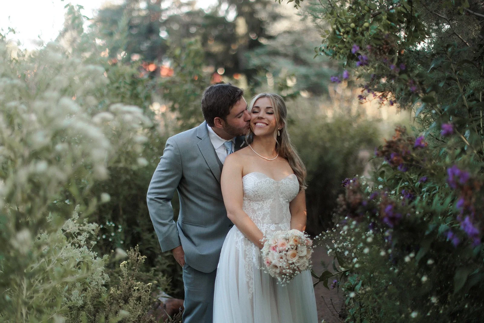 San Diego wedding photograph of groom kissing a bride in Balboa Park.