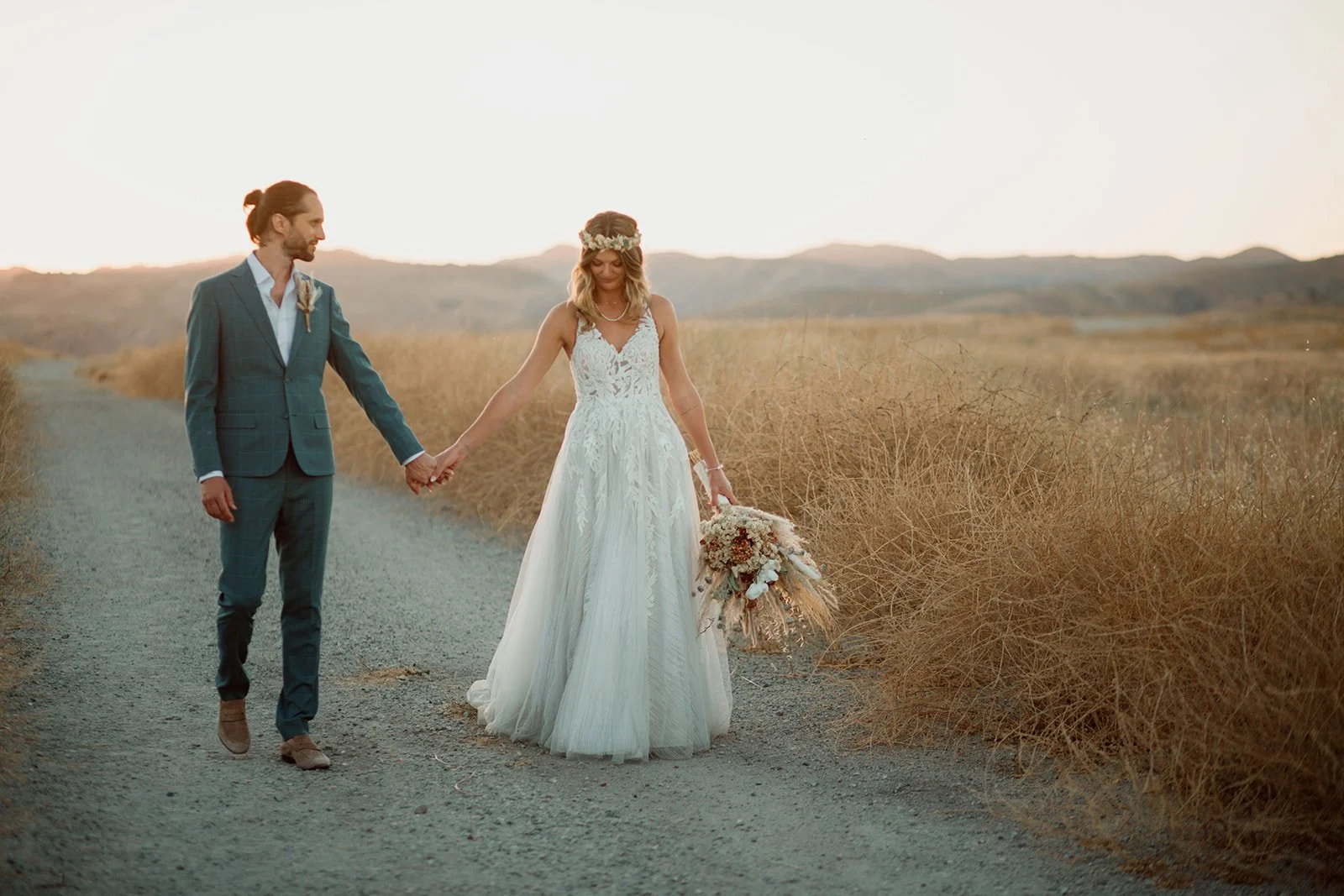 San Diego elopement photos of a couple walking hand in hand at Mission Trails Regional Park.