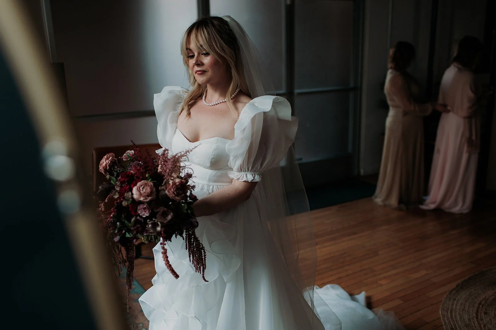 San Diego bride stands in bridal suite at her wedding in La Jolla.