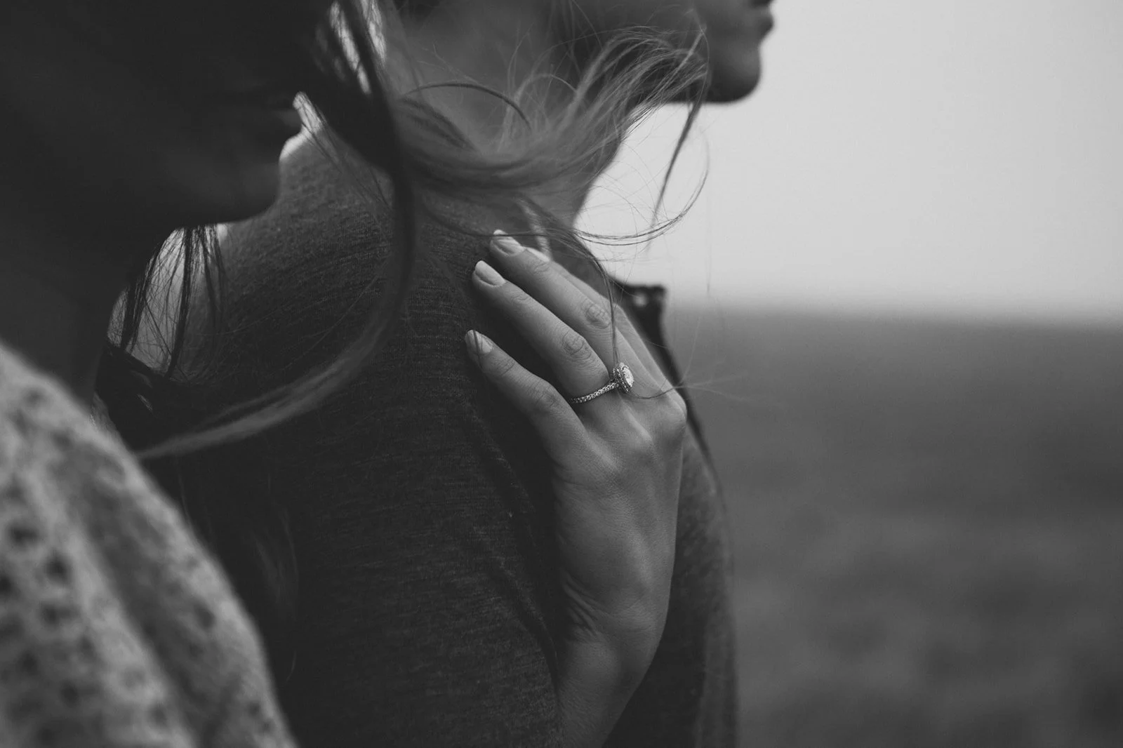Black and white photo of a San Diego engagement photo shoot showing the ring.