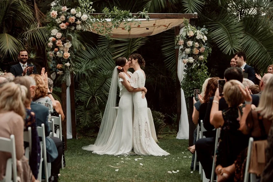 Two brides kiss at their San Diego Wedding ceremony at Paradise Point.