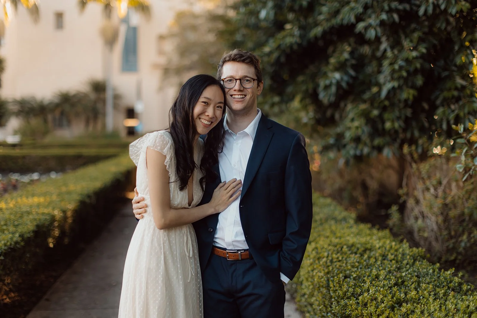 Bride to be hugs her fiancé after their Balboa Park wedding proposal in San Diego.