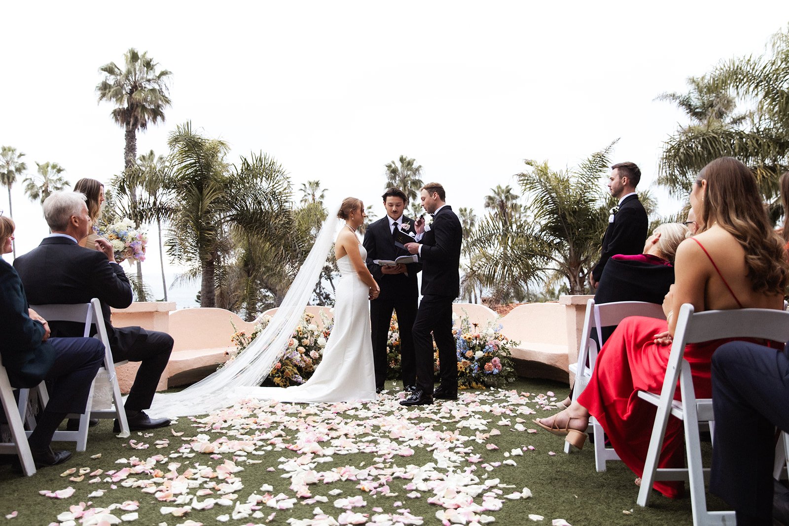 A bride and groom share their vows at their San Diego wedding ceremony at La Valencia in La Jolla.