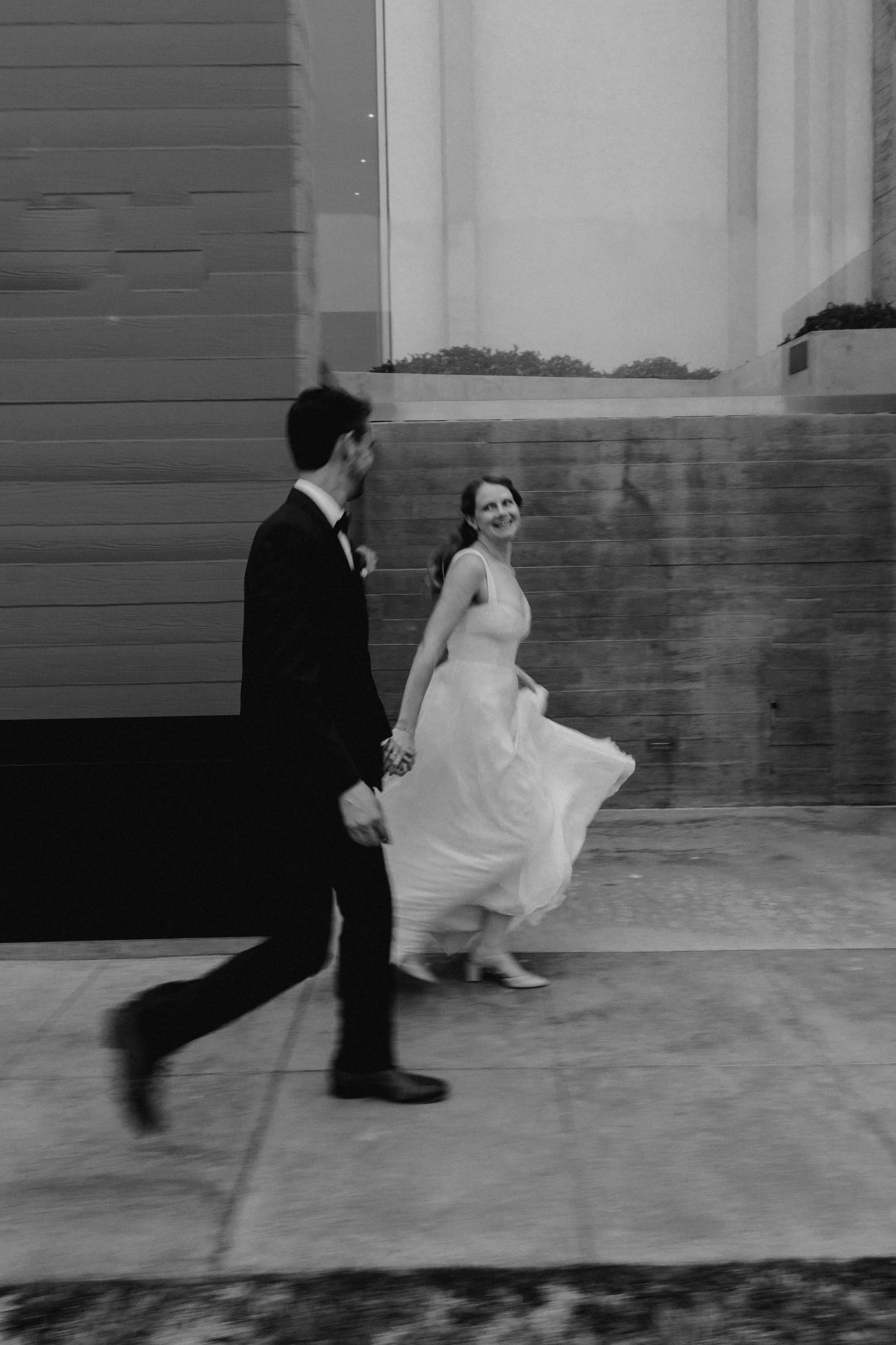 Bride and groom walking and smiling walking to their wedding ceremony  in La Jolla, San Diego.