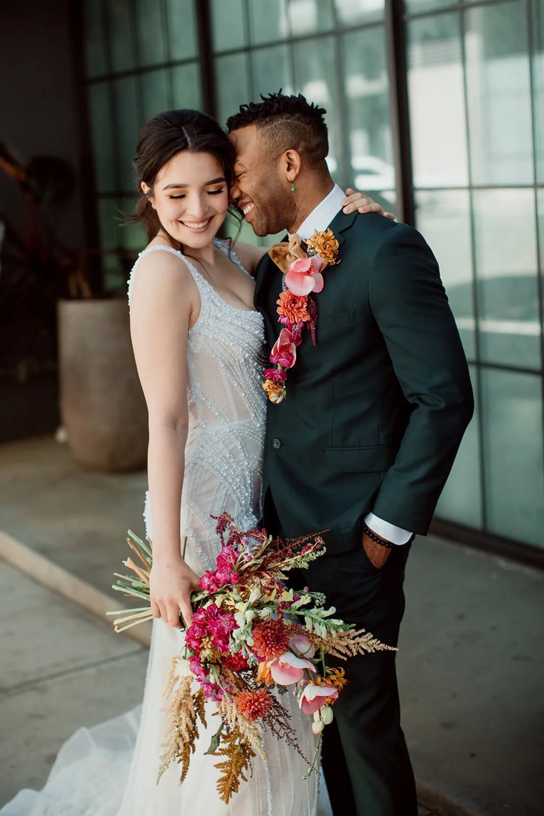 Couple's portraits in downtown in front of Flora the venue after their San Diego Courthouse elopement wedding.