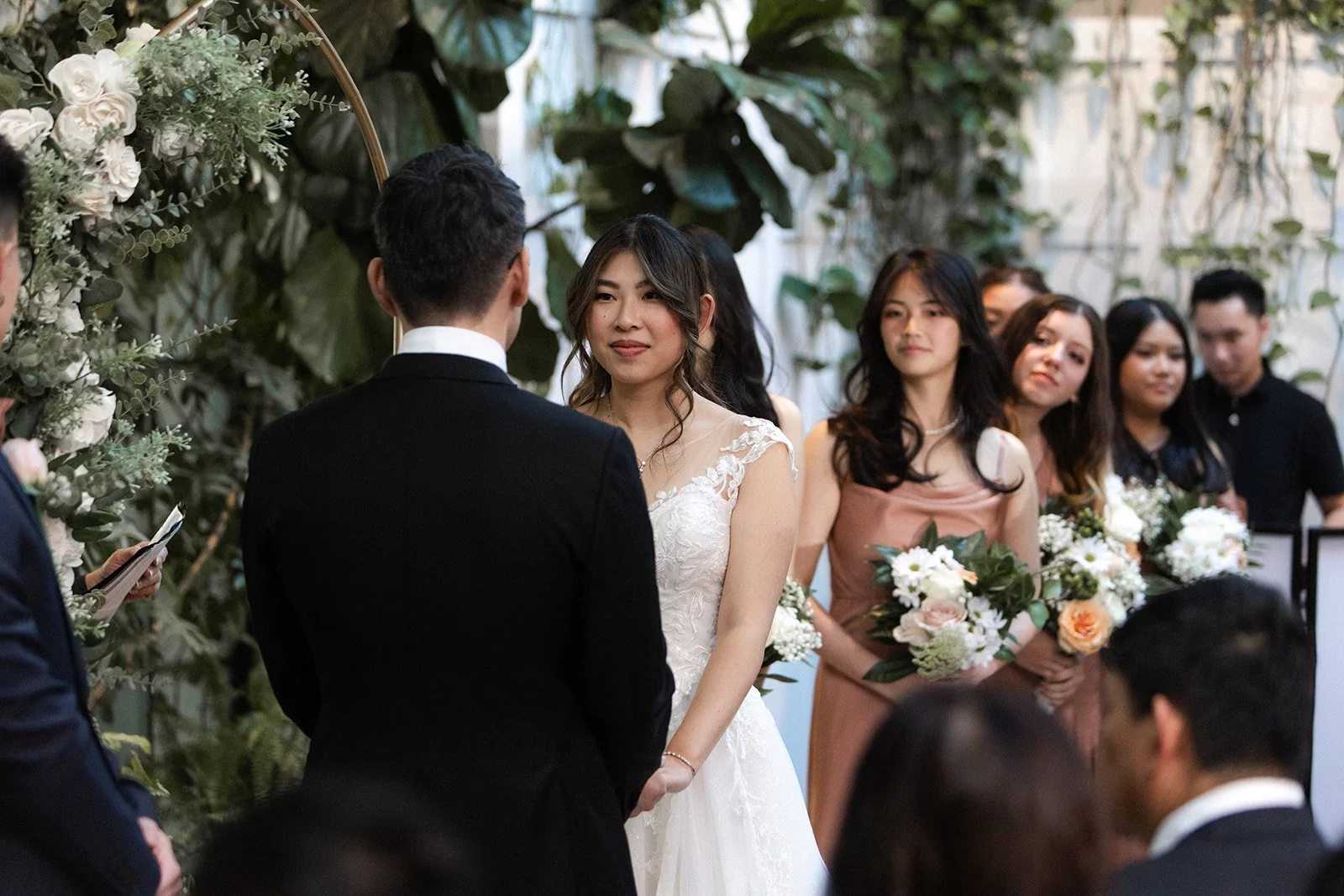 Bride looks at her groom during a wedding ceremony held at Flora the venue in downtown San Diego.