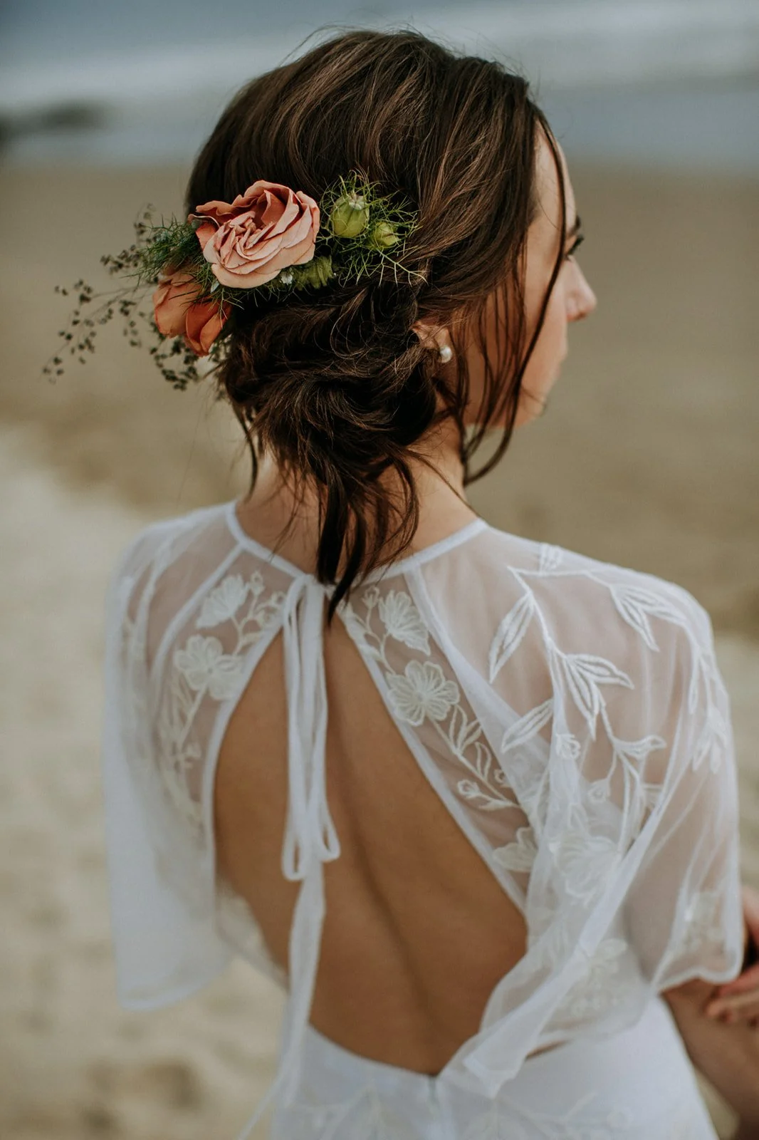 Bride on a San Diego beach with flowers in her hair.