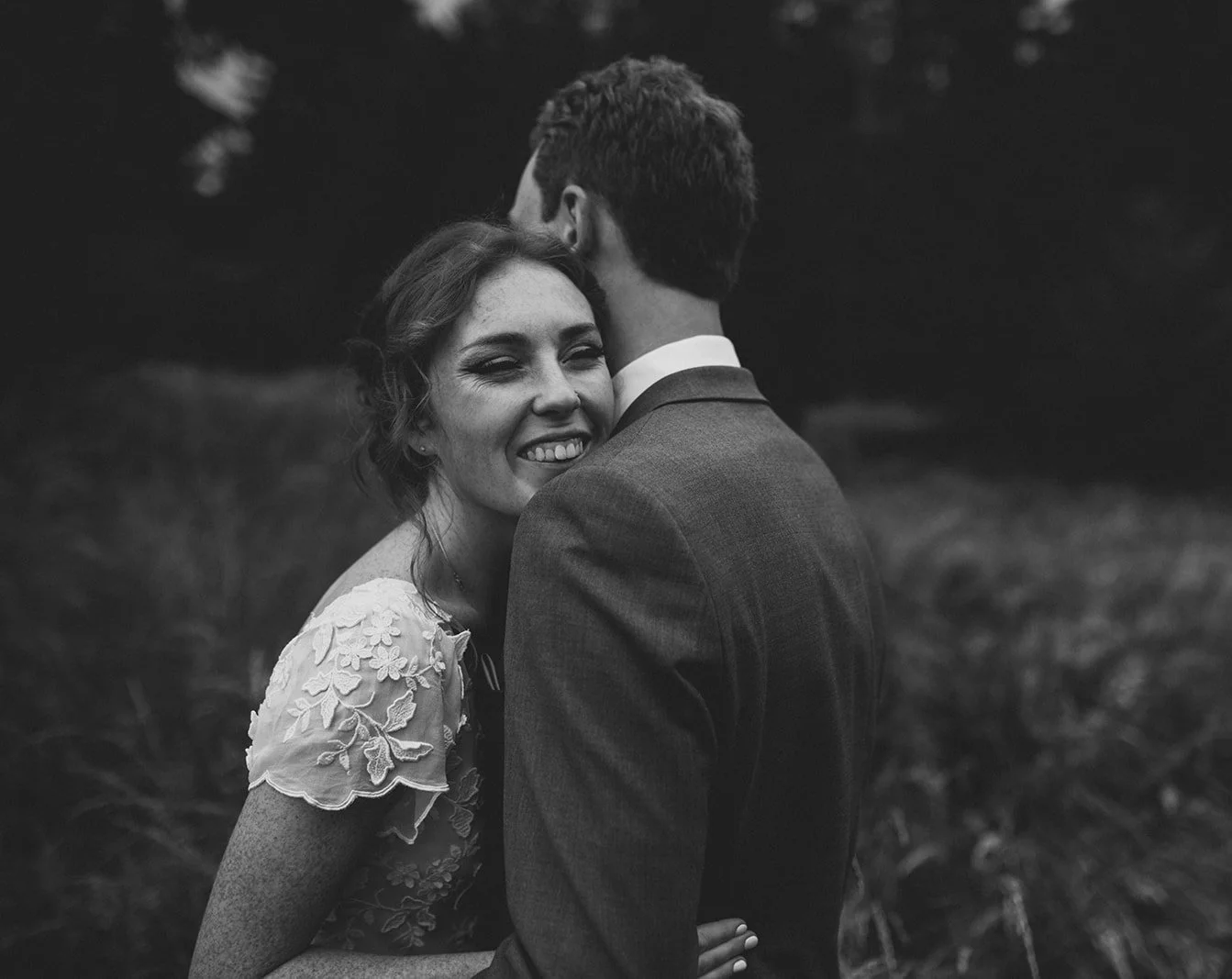 San Diego bride hugs her groom smiling after their wedding ceremony in Balboa Park.