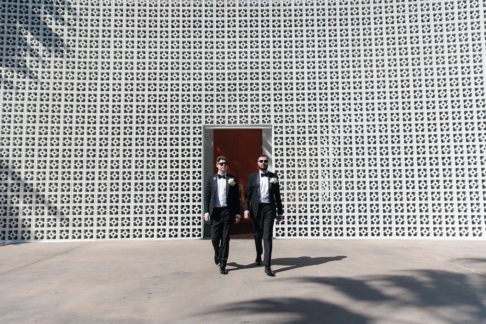 Grooms walk towards their wedding ceremony in Palm Springs.