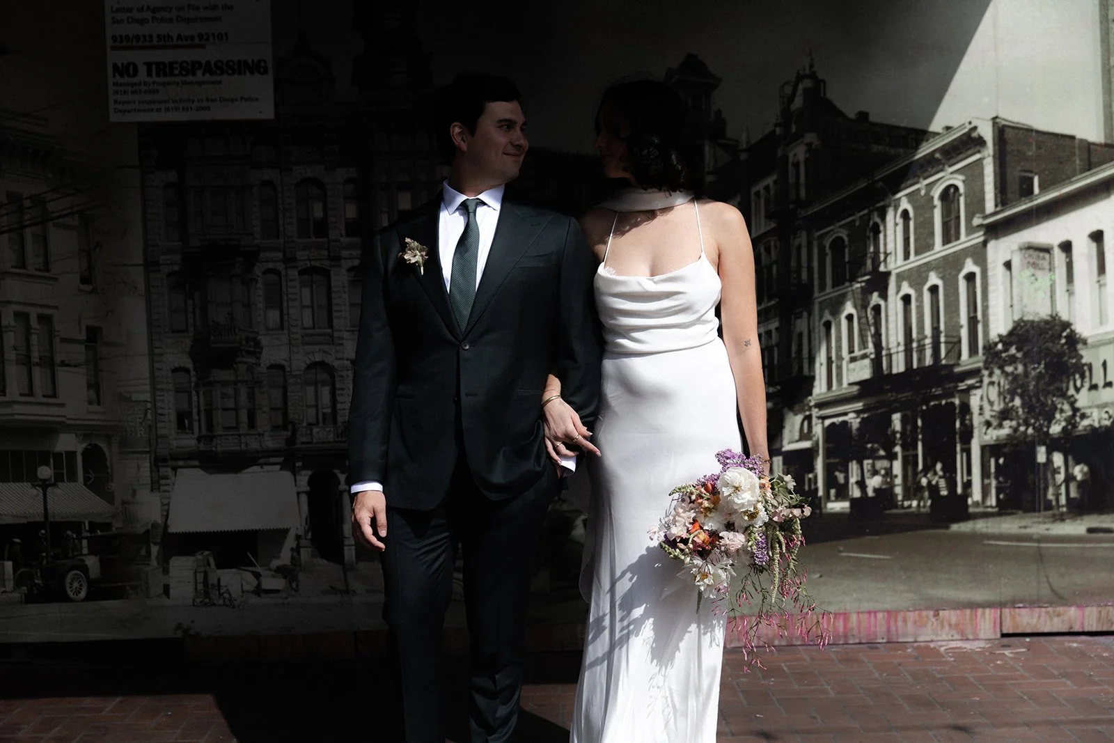 Bride and groom stand together in downtown San Diego for their wedding.