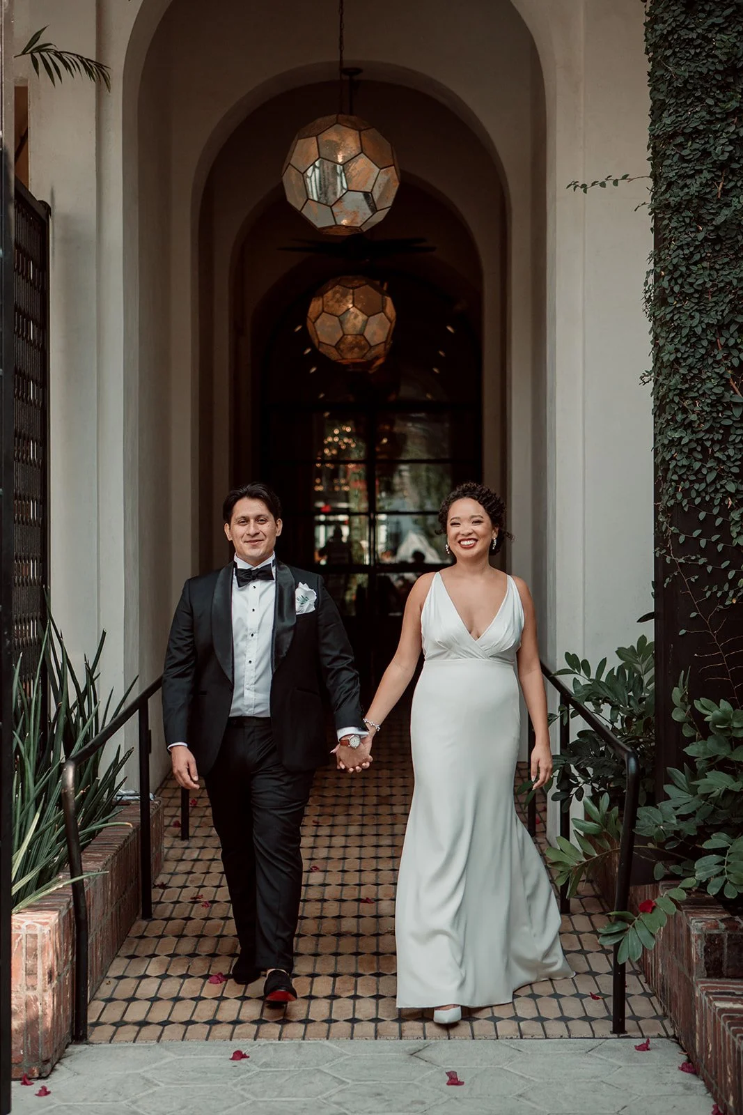 Bride and groom walk hand in hand at their Los Angeles wedding.