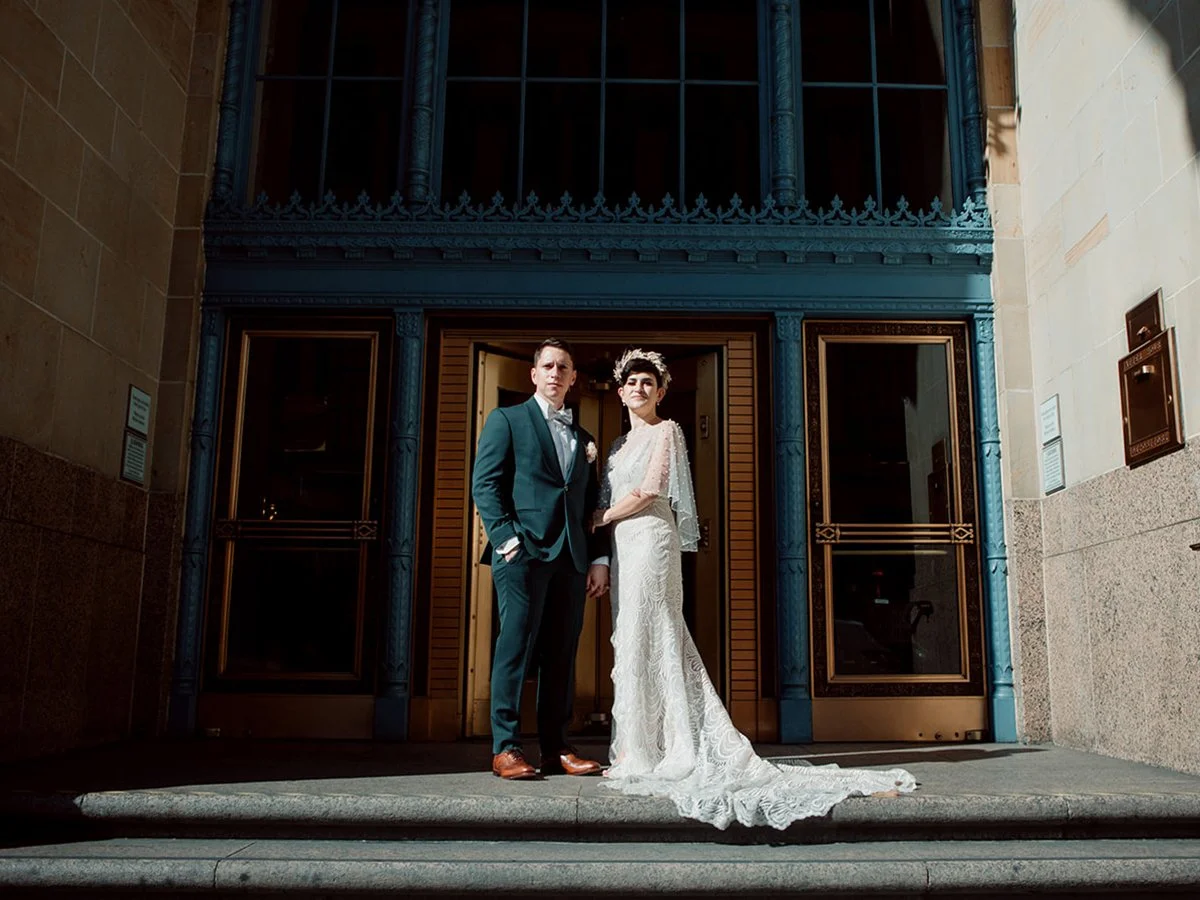 Couples stands for their portraits after their San Diego Courthouse wedding ceremony.