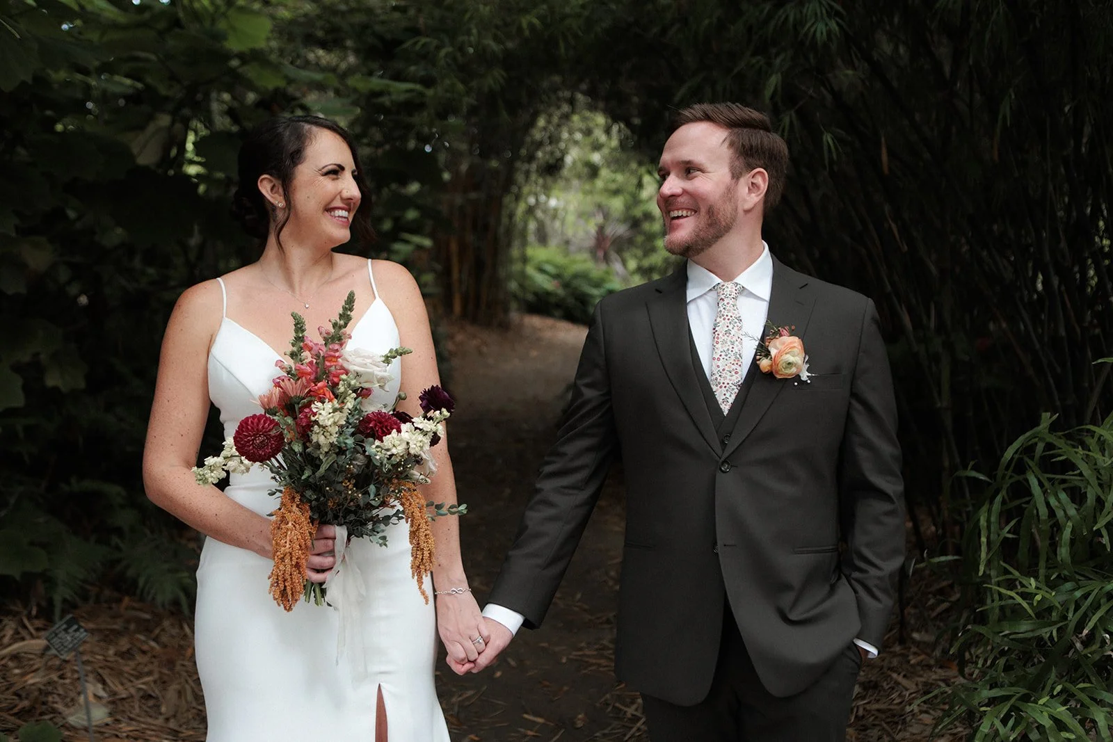 Couple holds hands and smiles, San Diego courthouse wedding elopement photo package. 