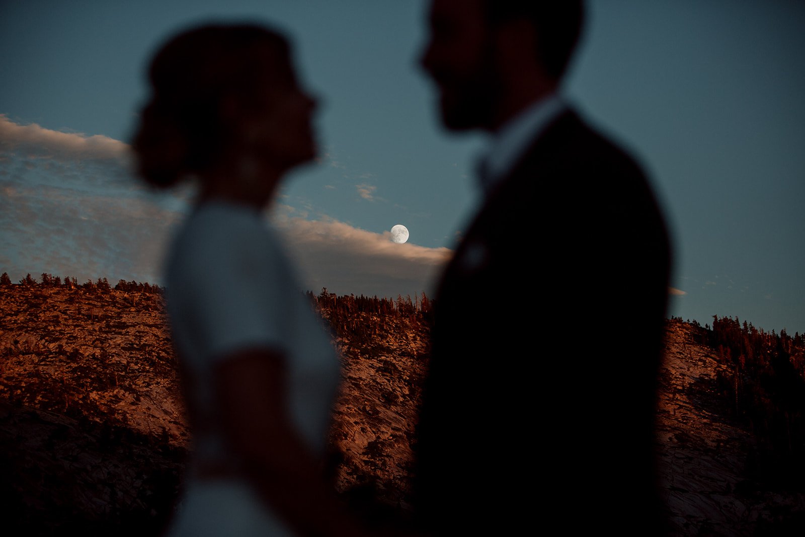 San Diego elopement photographer captures couple in front of rising moon.