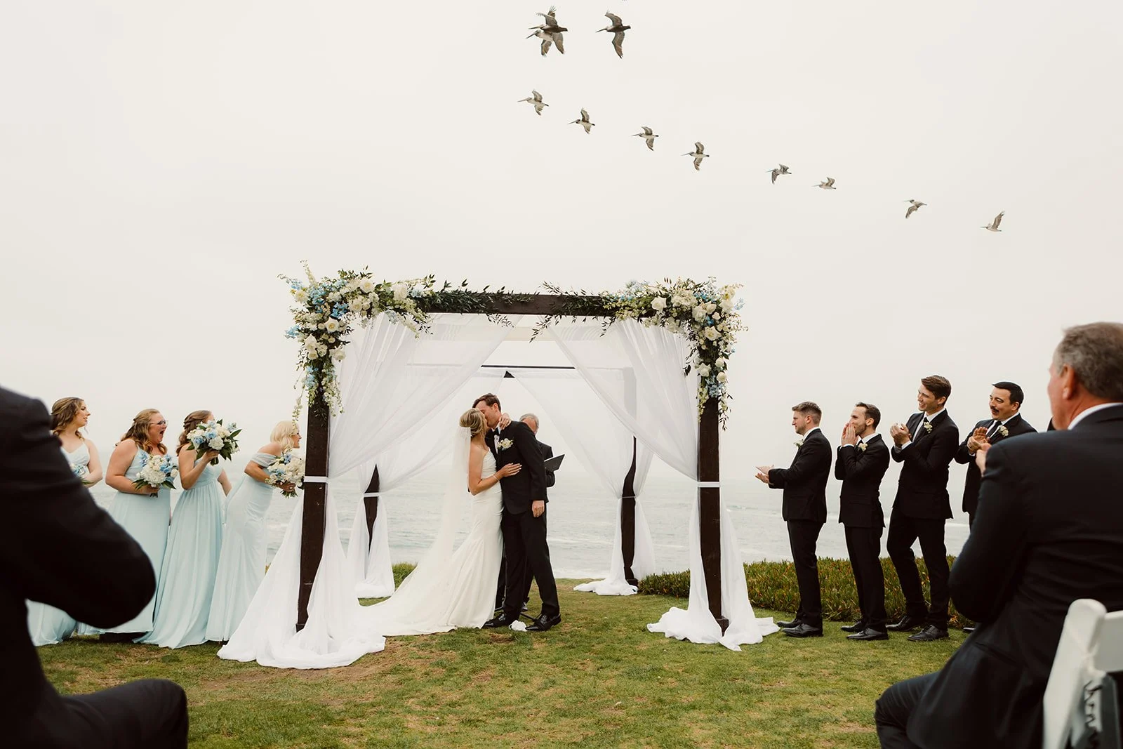 First kiss at San Diego coastal wedding ceremony in La Jolla.